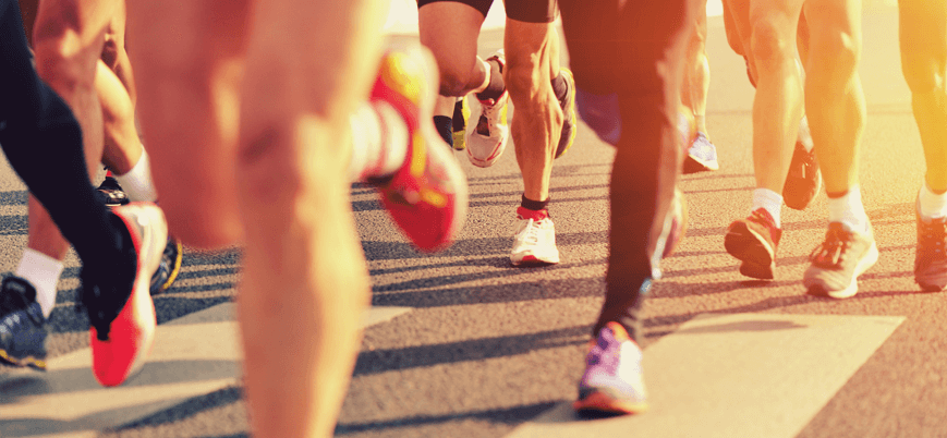 People running a race with healthy legs - Palisades Vein Center