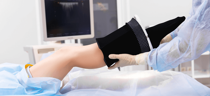 patient receiving compression stockings - Palisades Vein Center